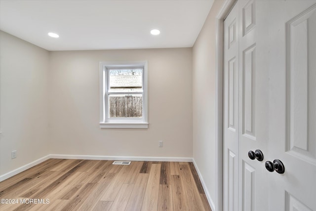 empty room with light hardwood / wood-style floors