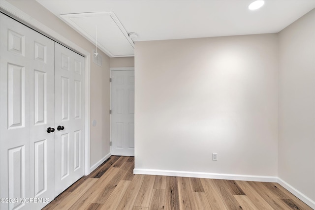 unfurnished bedroom featuring a closet and light hardwood / wood-style floors