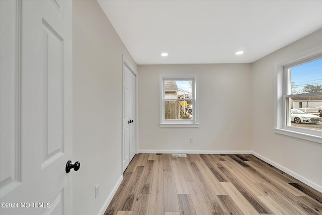 unfurnished bedroom featuring light hardwood / wood-style floors and multiple windows