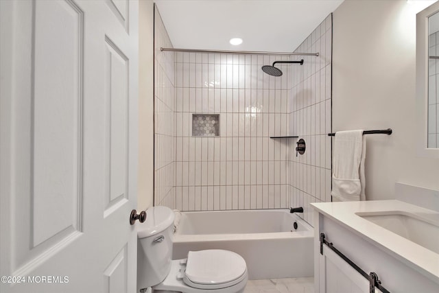 full bathroom with vanity, toilet, and tiled shower / bath