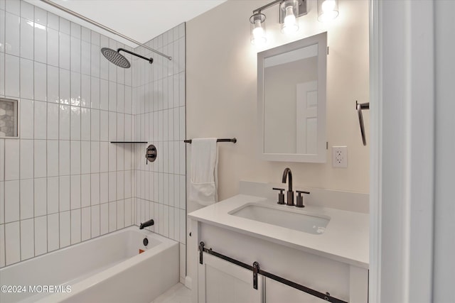 bathroom with tiled shower / bath combo and vanity