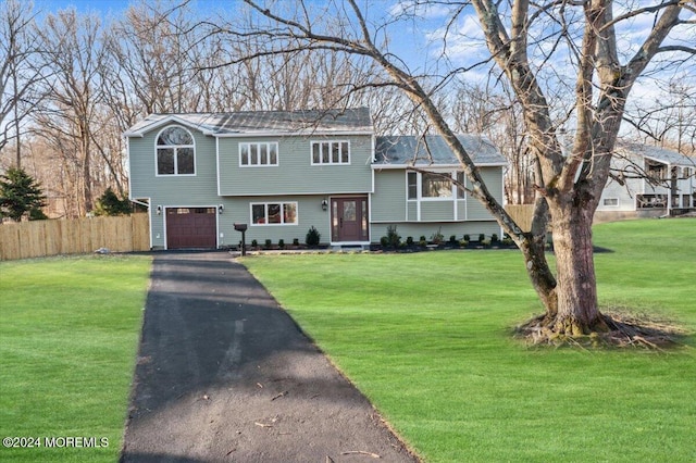 view of front facade with a garage and a front yard