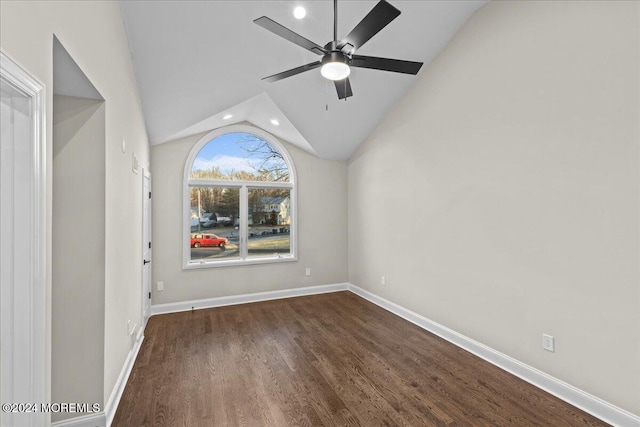 empty room featuring dark hardwood / wood-style flooring, vaulted ceiling, and ceiling fan