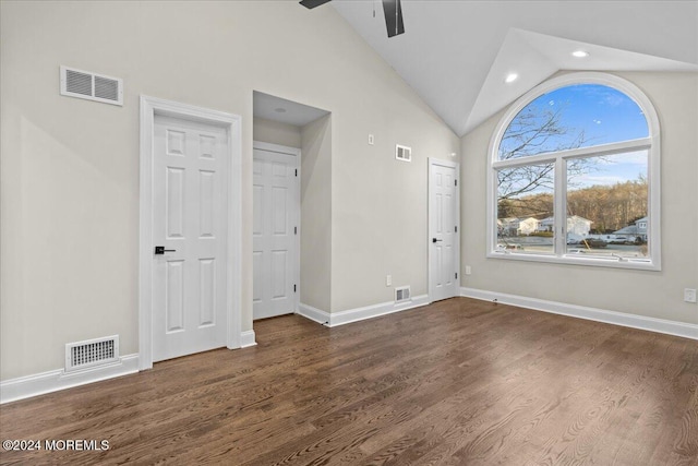 interior space featuring ceiling fan, dark wood-type flooring, and high vaulted ceiling