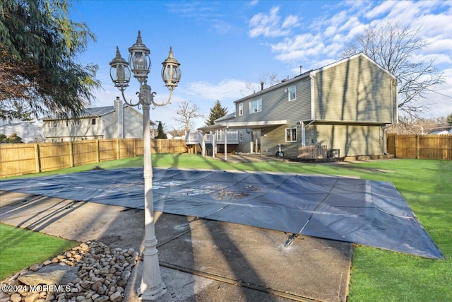 view of swimming pool with a lawn and a patio