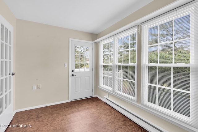 doorway with dark hardwood / wood-style flooring and baseboard heating