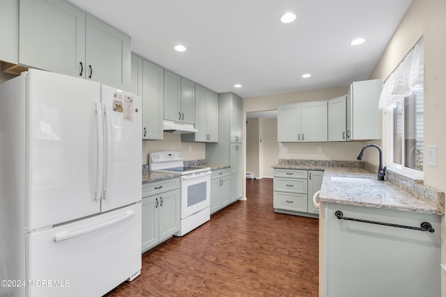 kitchen featuring light stone countertops, sink, dark hardwood / wood-style floors, white appliances, and white cabinets