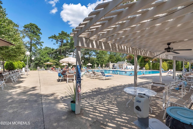 view of pool featuring ceiling fan, a patio area, and a pergola