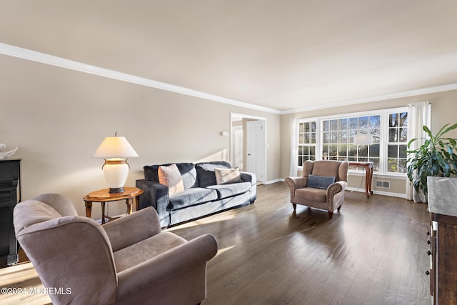 living room with dark hardwood / wood-style flooring and ornamental molding