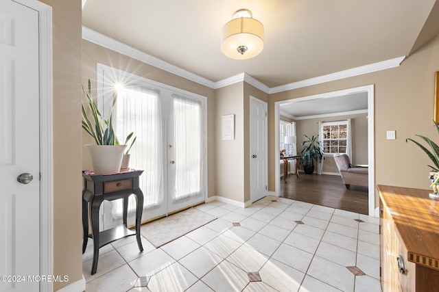 tiled entryway featuring ornamental molding, a wealth of natural light, and french doors