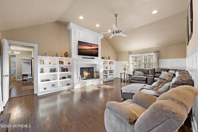 living room with a fireplace, dark hardwood / wood-style flooring, ceiling fan, and lofted ceiling