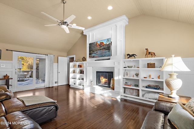 living room featuring hardwood / wood-style floors, ceiling fan, high vaulted ceiling, and a brick fireplace