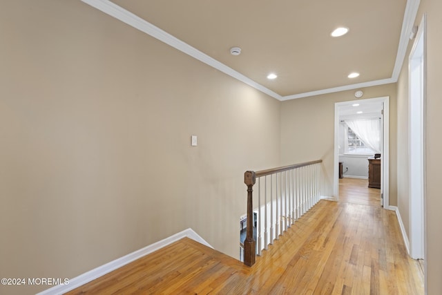 hall featuring light hardwood / wood-style floors and crown molding