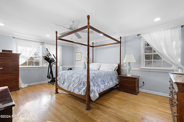 bedroom featuring light hardwood / wood-style flooring, ceiling fan, and crown molding