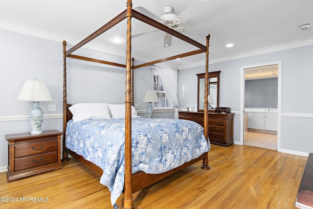 bedroom featuring ceiling fan, light hardwood / wood-style floors, ensuite bathroom, and crown molding