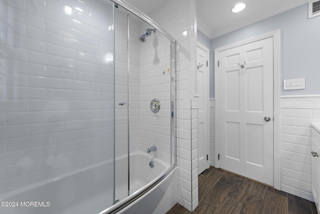 bathroom featuring ornamental molding and bath / shower combo with glass door