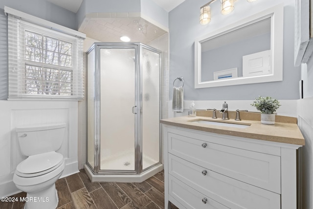 bathroom with vanity, toilet, and an enclosed shower