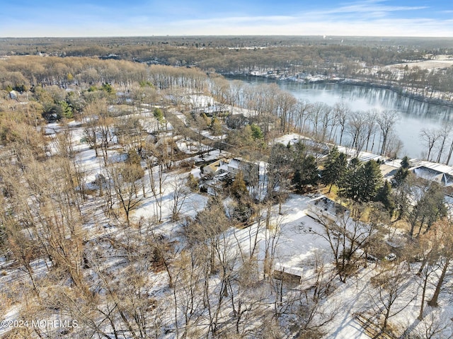 snowy aerial view featuring a water view