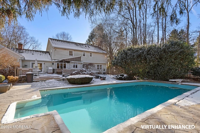 view of swimming pool featuring a patio area and a diving board