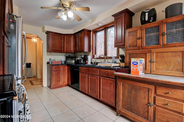 kitchen featuring stove, sink, ceiling fan, light tile patterned floors, and black dishwasher