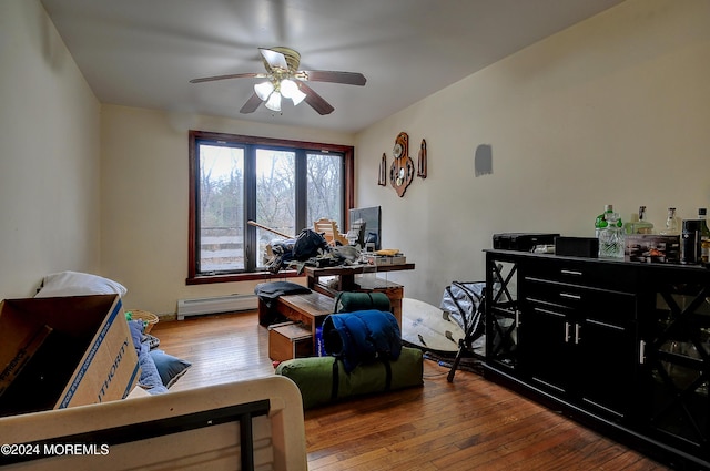 interior space with hardwood / wood-style floors, ceiling fan, and a baseboard radiator