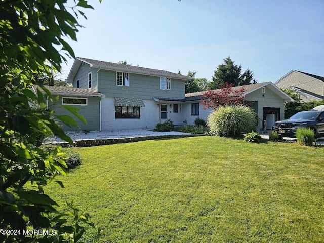 back of house featuring a lawn