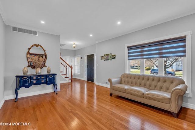 living room featuring light hardwood / wood-style floors and ornamental molding