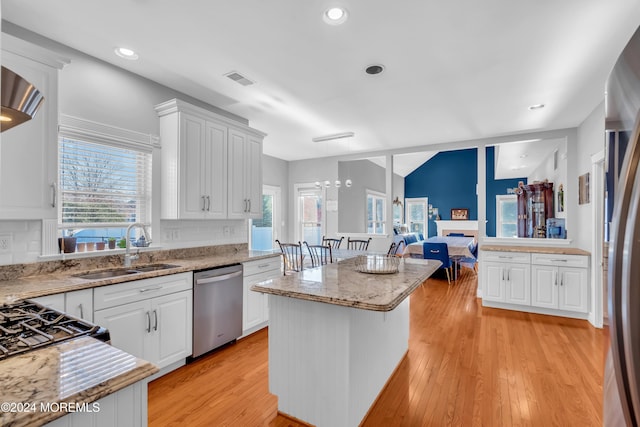 kitchen featuring a healthy amount of sunlight, white cabinetry, and stainless steel appliances