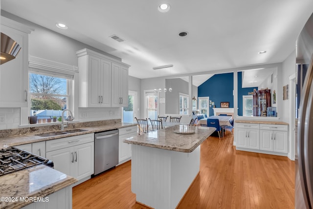 kitchen featuring appliances with stainless steel finishes, white cabinetry, and a wealth of natural light