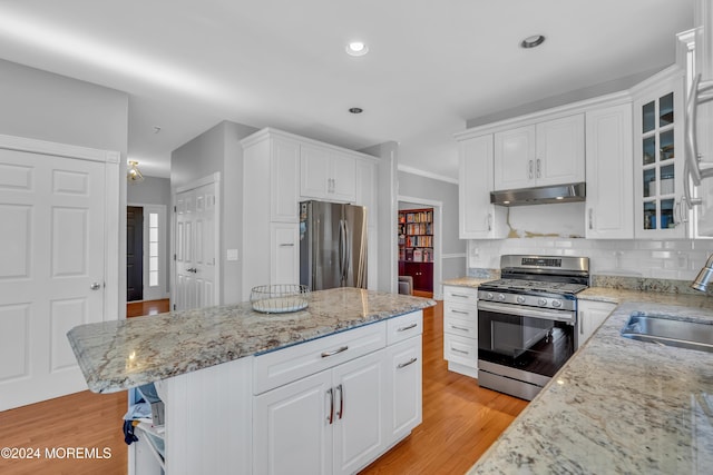 kitchen featuring white cabinets, light wood-type flooring, sink, and appliances with stainless steel finishes