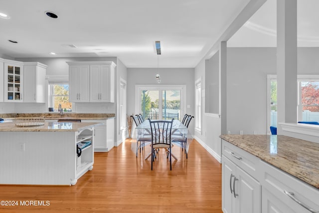 kitchen featuring plenty of natural light, white cabinets, and light wood-type flooring