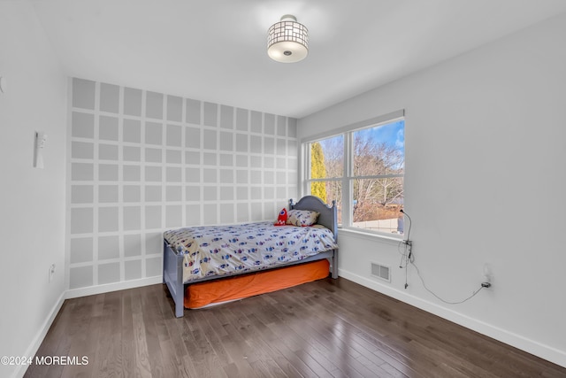 bedroom with dark wood-type flooring