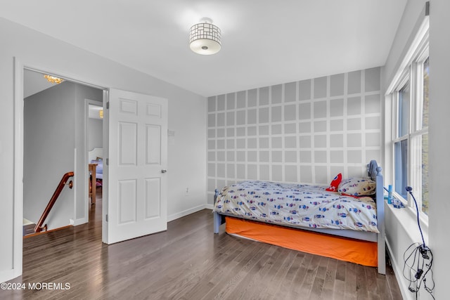 bedroom featuring multiple windows and hardwood / wood-style floors