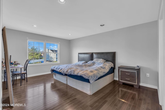 bedroom with dark wood-type flooring