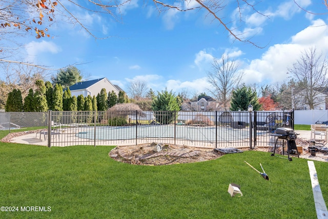 view of swimming pool featuring a lawn, a patio, and grilling area