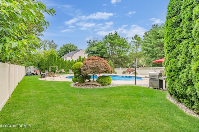 view of yard with a fenced in pool