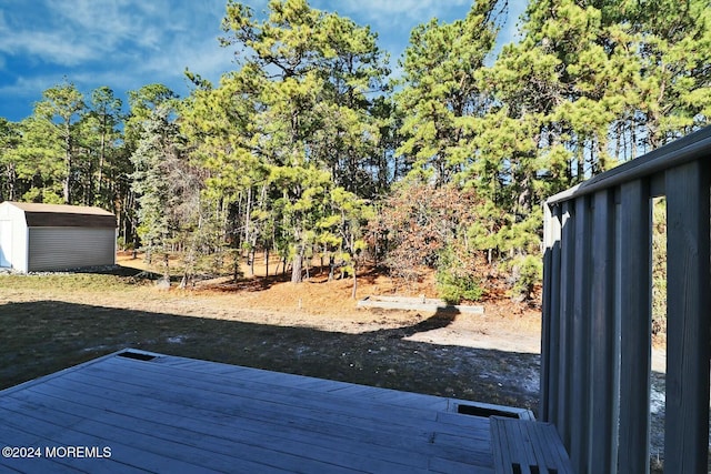 view of yard with a storage shed and a wooden deck