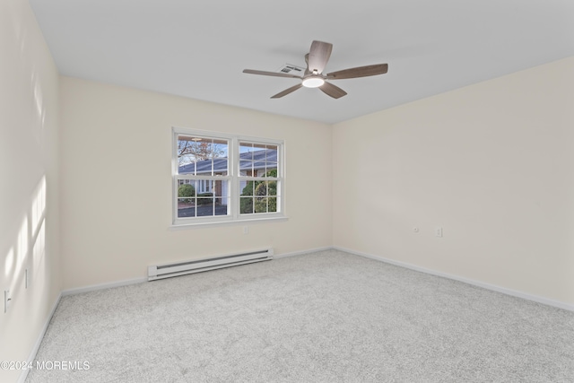 carpeted empty room featuring baseboard heating and ceiling fan