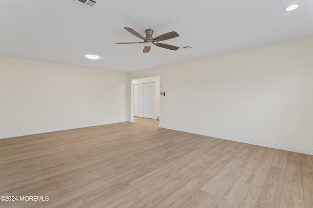 spare room featuring ceiling fan and light hardwood / wood-style floors