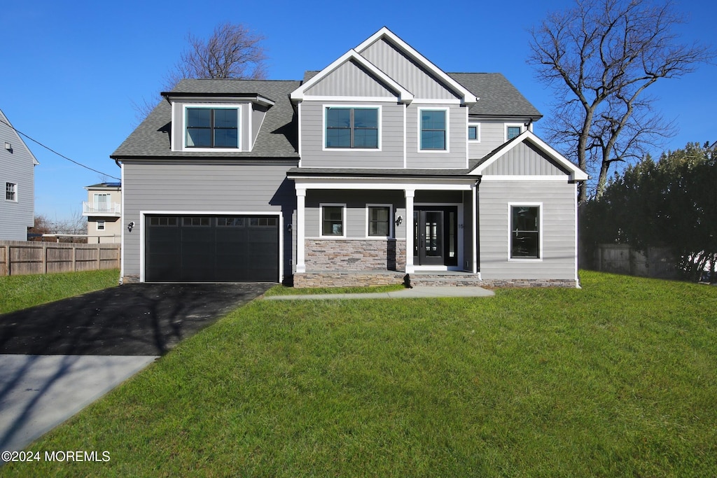 view of front of property featuring a garage and a front lawn