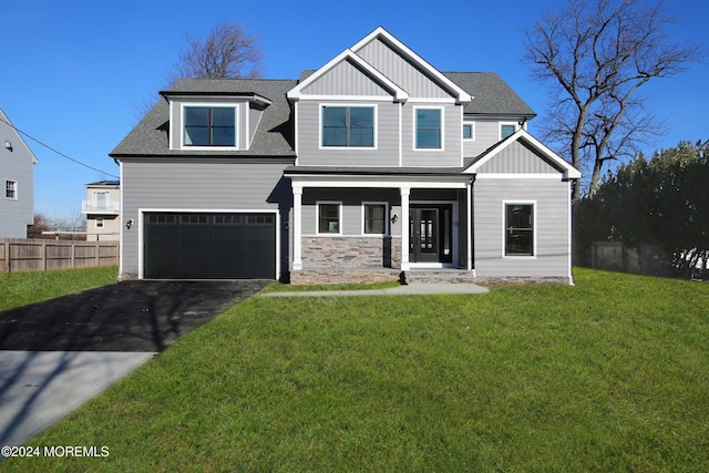 view of front of property featuring a garage and a front lawn