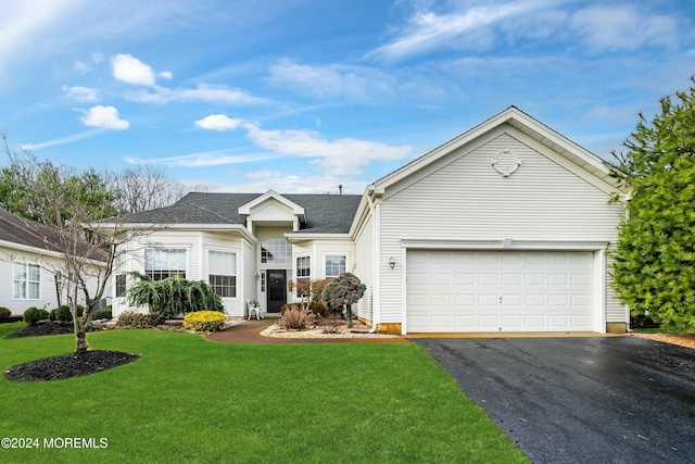 ranch-style home featuring a front lawn and a garage