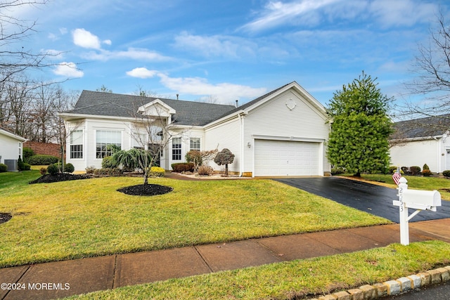 ranch-style home with central AC unit, a garage, and a front lawn