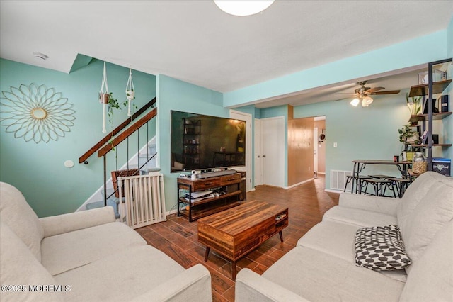 living room with ceiling fan and dark hardwood / wood-style floors