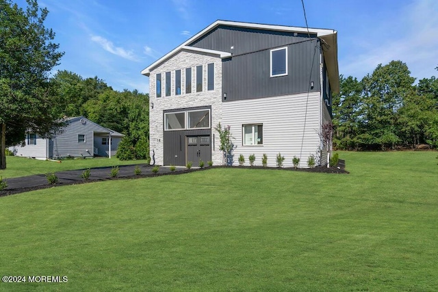 back of house with a lawn