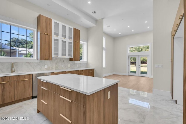 kitchen with a center island, a healthy amount of sunlight, sink, and french doors