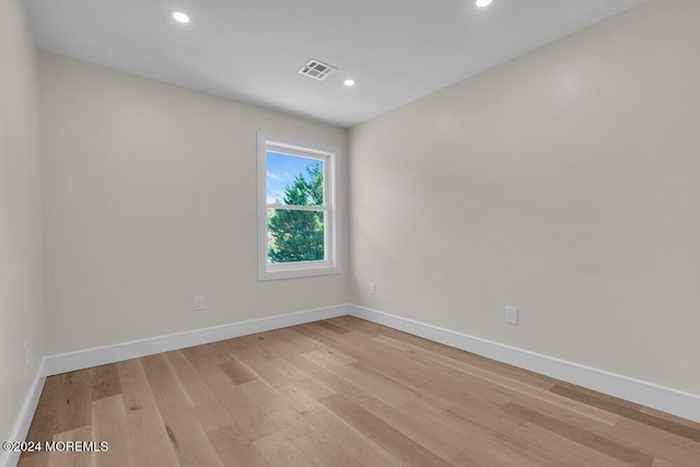 empty room with light hardwood / wood-style flooring