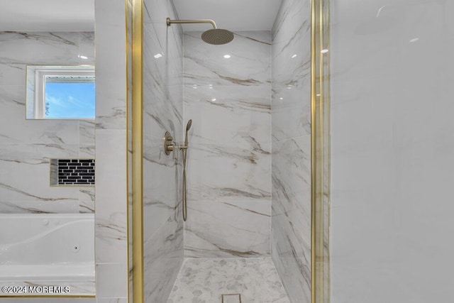 bathroom featuring shower with separate bathtub