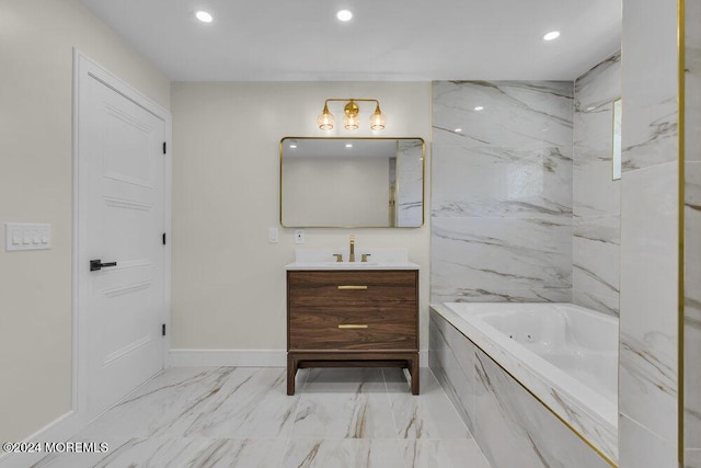 bathroom featuring tiled tub and vanity