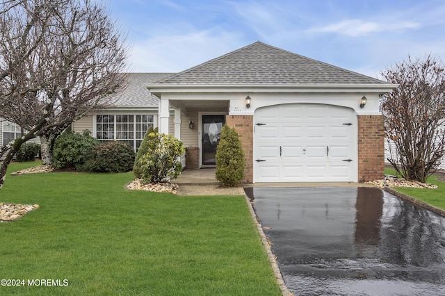 single story home with a front yard and a garage